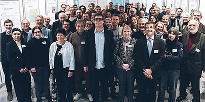 Group photo of participants at the Bilateral AI workshop. The diverse group includes researchers and professionals, smiling and posing together, reflecting collaboration and exchange in AI research.